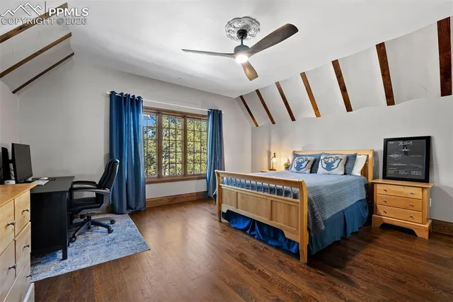 a bedroom with a bed window and a dresser