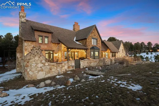 an aerial view of a house with a yard and lake view