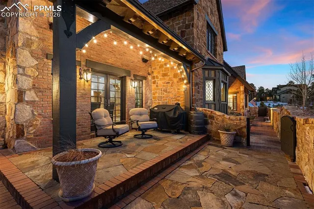 a living room with couches a barbecue grill with dining table and chairs