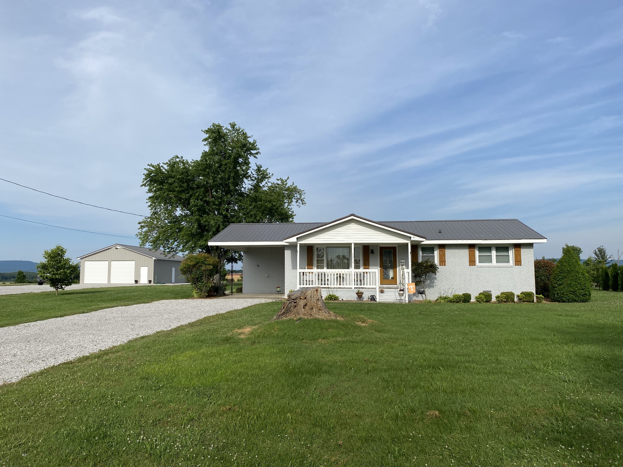 3216 Oak Grove Road Decherd, TN 37324 - Photo 4 of 27 a front view of a house with a garden