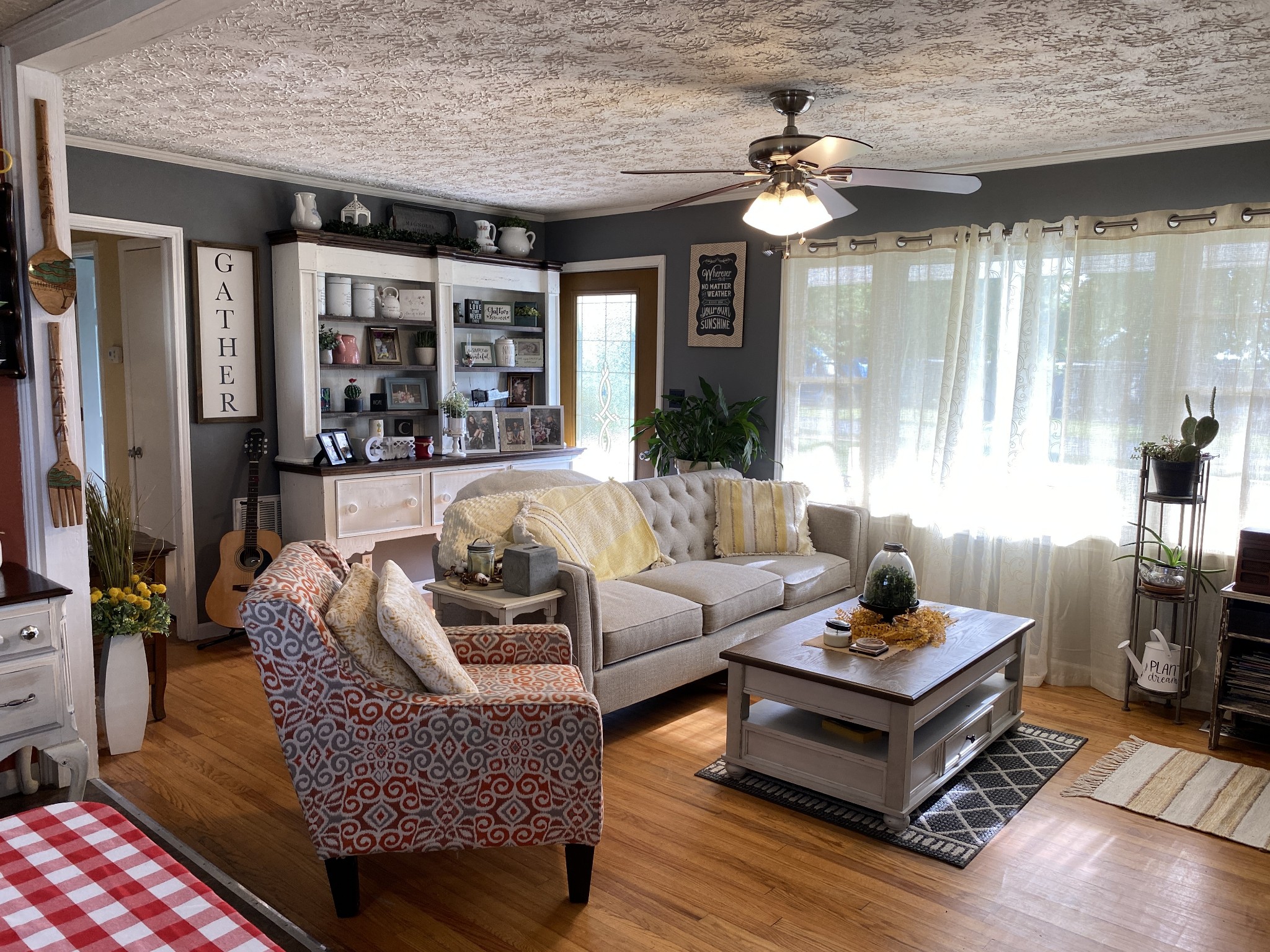3216 Oak Grove Road Decherd, TN 37324 - Photo 8 of 27 a living room with furniture a chandelier and a large window