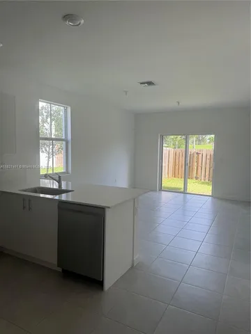 a room with a window and a sink dishwasher next to a window