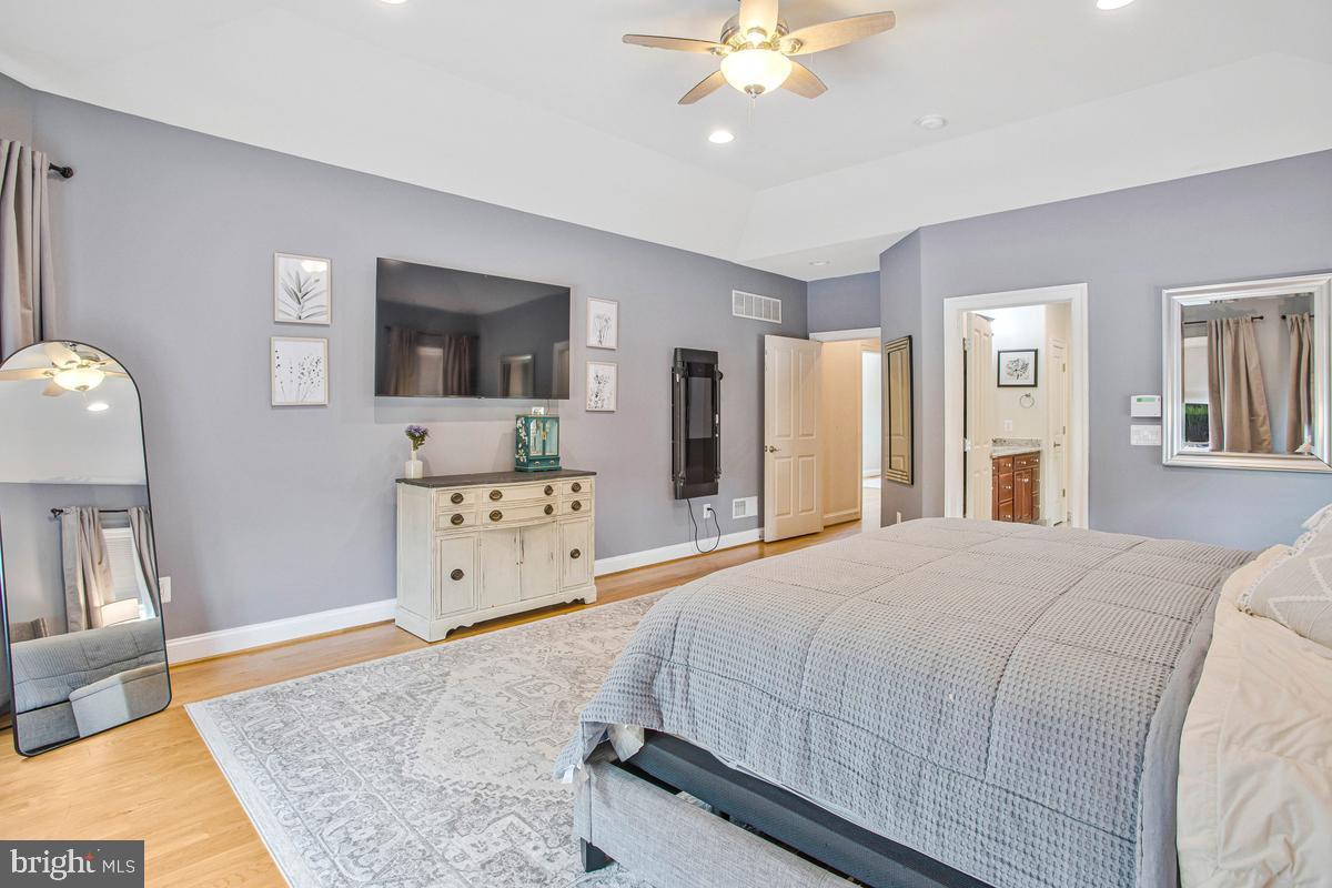 5 Jessie Road Harwood, MD 20776 - Photo 38 of 87 a spacious bedroom with a bed and a flat screen tv