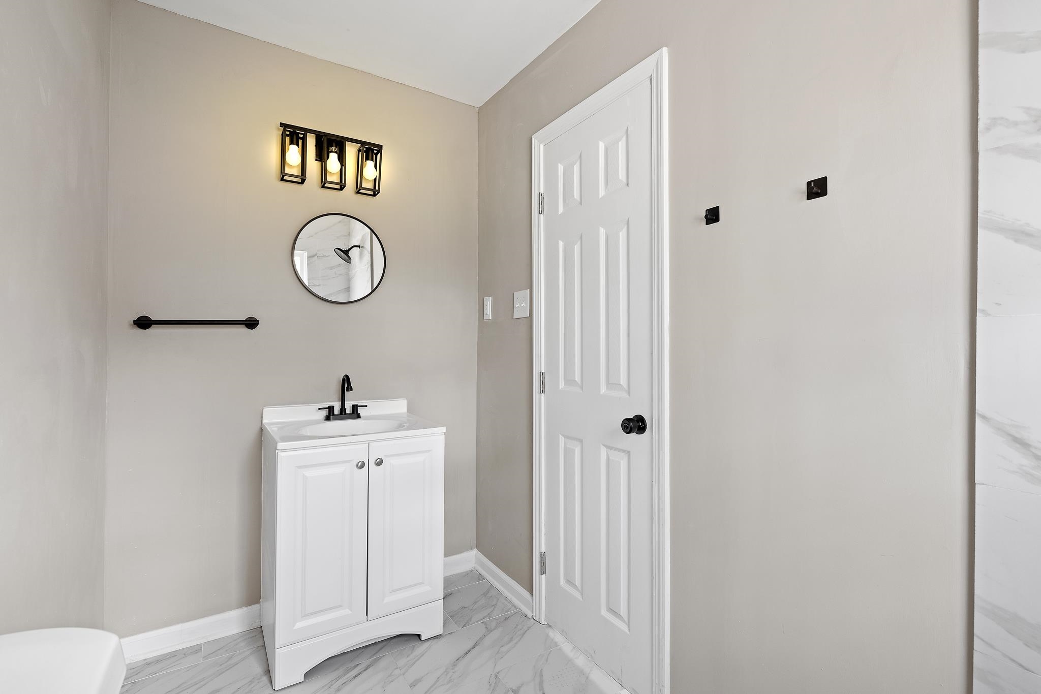 4375 Macon Road Memphis, TN 38122 - Photo 11 of 17 a view of a bathroom with a sink and a mirror