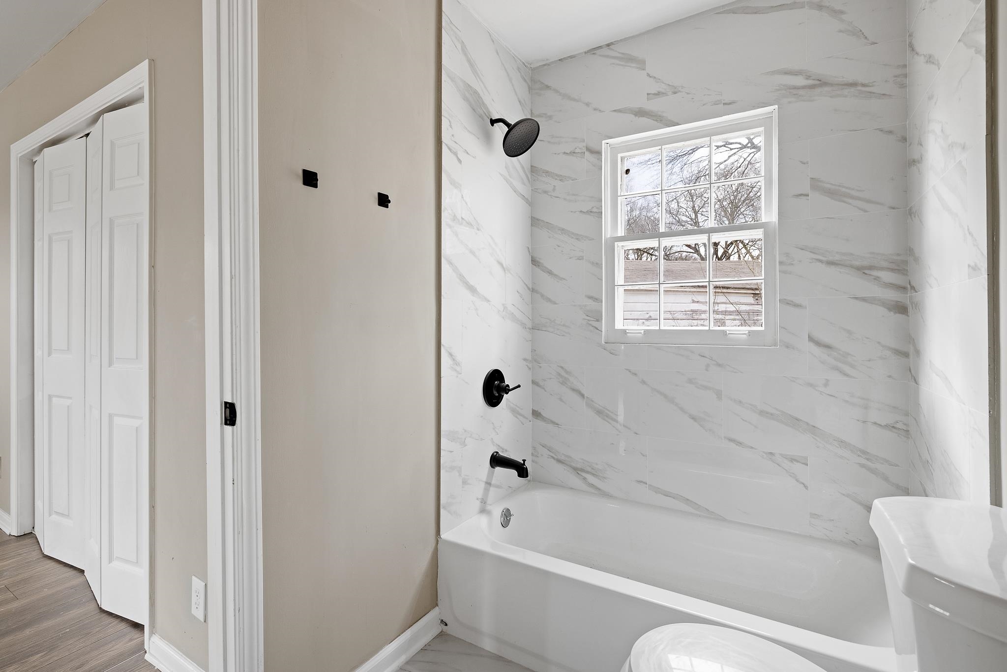 4375 Macon Road Memphis, TN 38122 - Photo 12 of 17 a bathroom with a bathtub shower and toilet