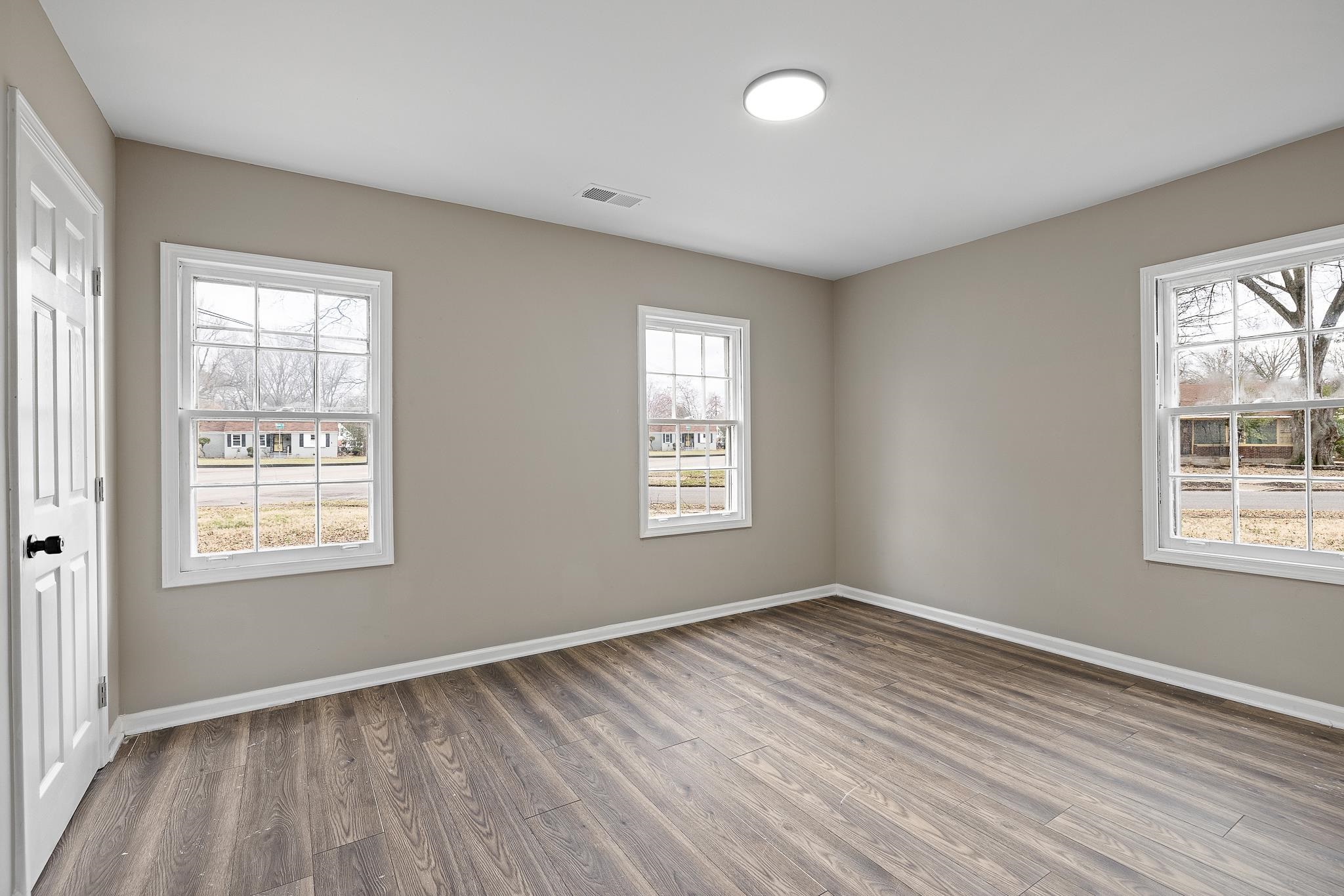 4375 Macon Road Memphis, TN 38122 - Photo 13 of 17 an empty room with wooden floor and windows