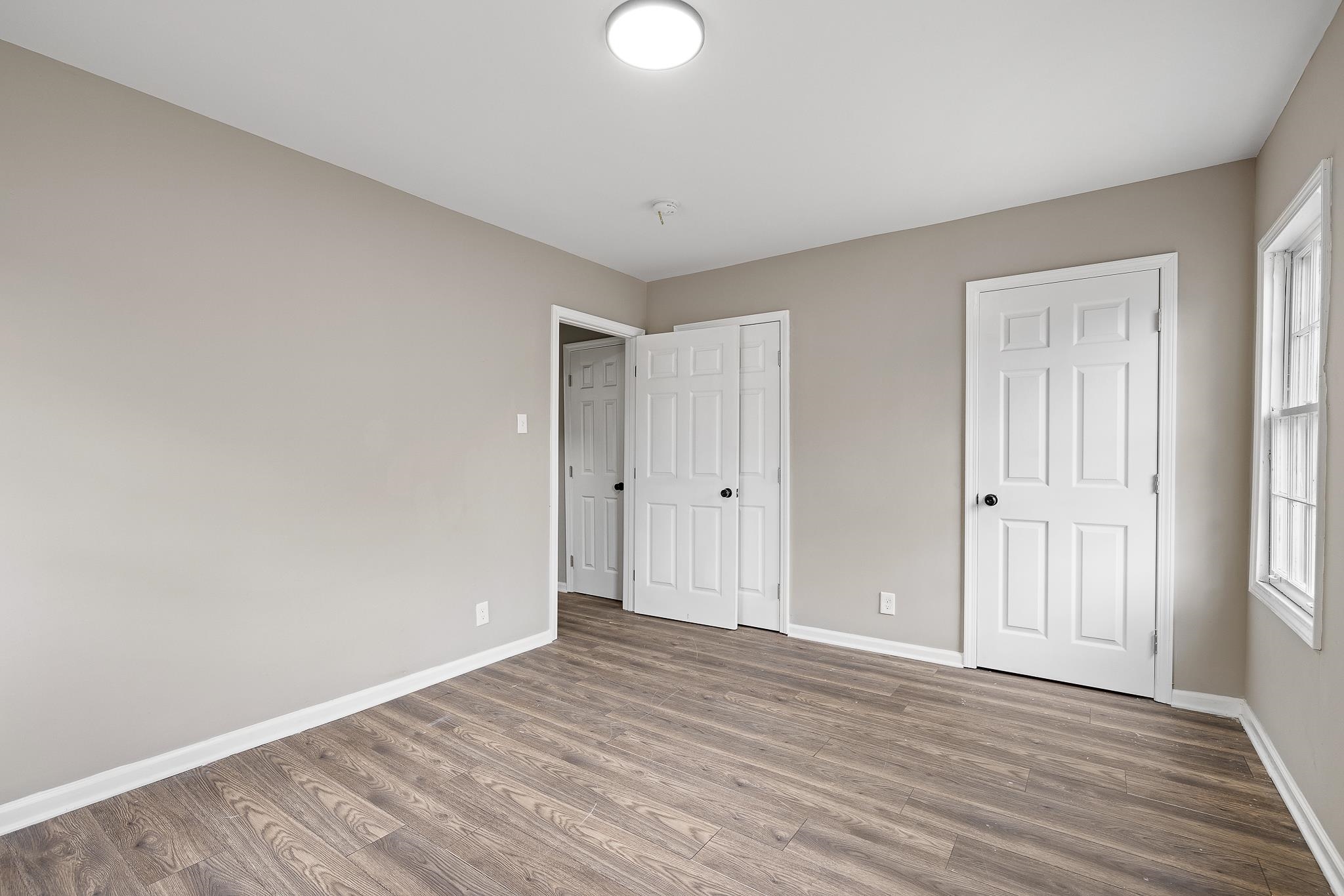 4375 Macon Road Memphis, TN 38122 - Photo 14 of 17 a view of an empty room with wooden floor and closet