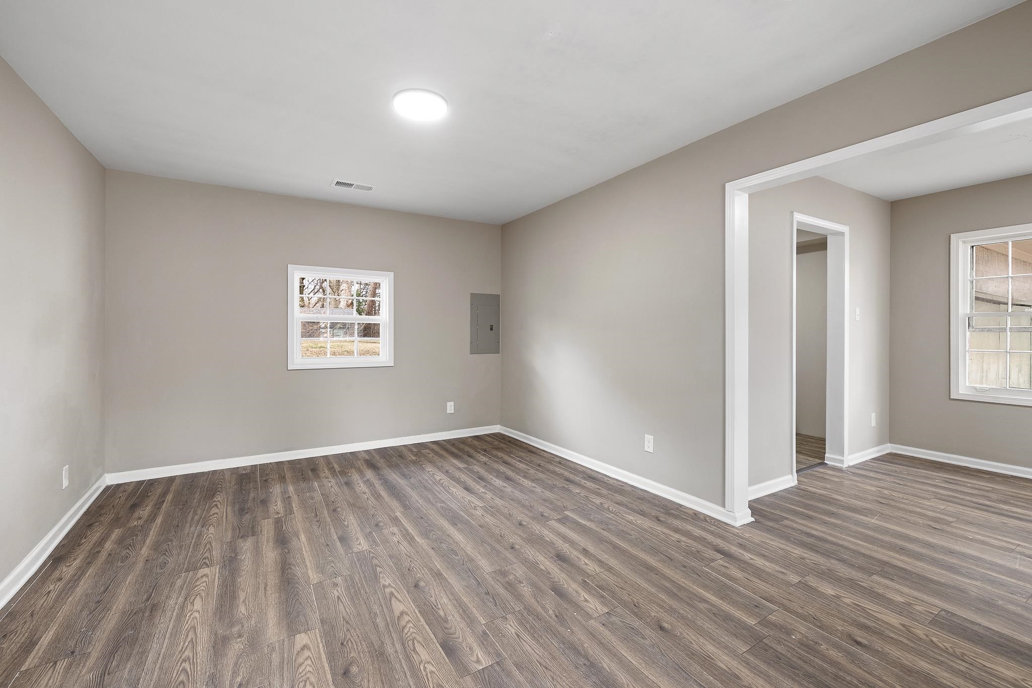 4375 Macon Road Memphis, TN 38122 - Photo 5 of 17 a view of an empty room with wooden floor and a window