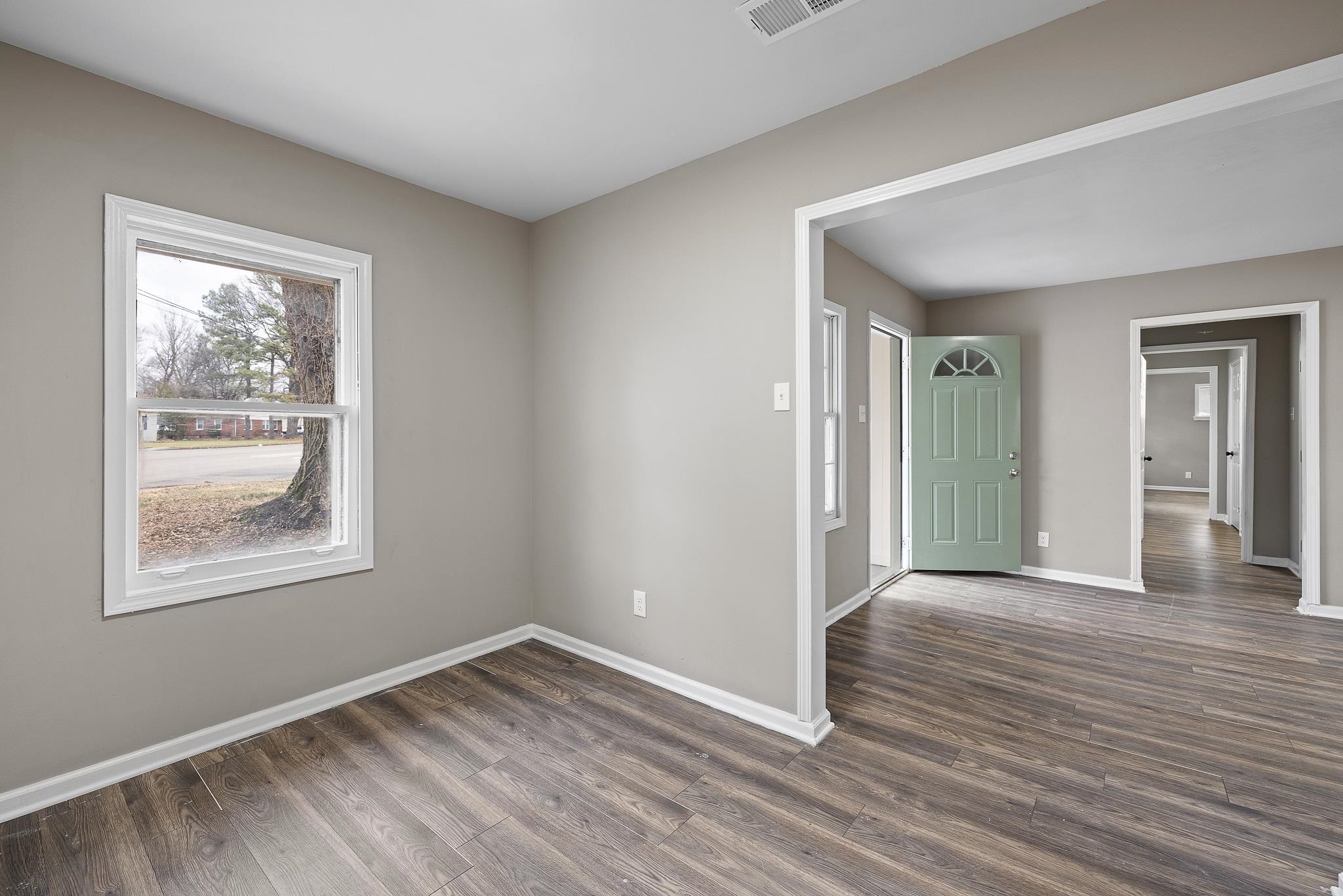 4375 Macon Road Memphis, TN 38122 - Photo 7 of 17 a view of an empty room with wooden floor and a window