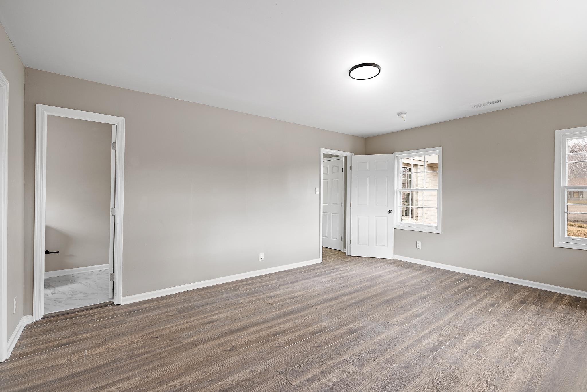 4375 Macon Road Memphis, TN 38122 - Photo 10 of 17 a view of an empty room with wooden floor and a window