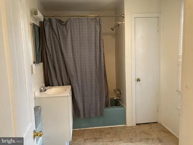 a view of a storage & utility room with a refrigerator