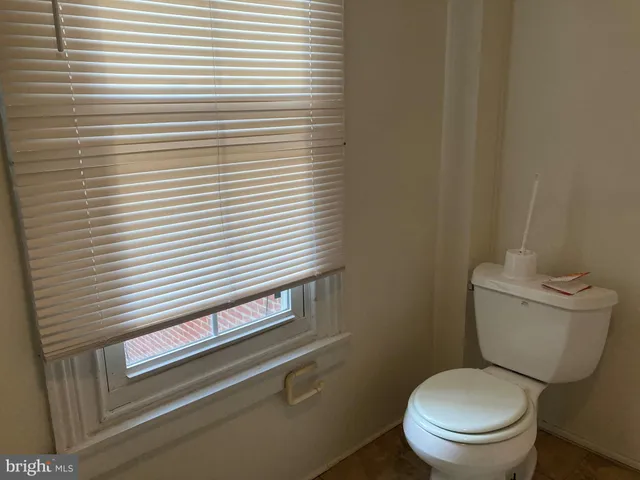 a white toilet sitting next to a white sink