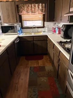 a kitchen with stainless steel appliances a sink stove and cabinets