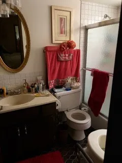 a bathroom with a toilet sink and mirror
