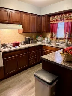 a kitchen with a sink and a stove top oven