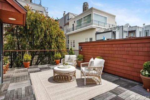 a view of a balcony with wooden floor and city view