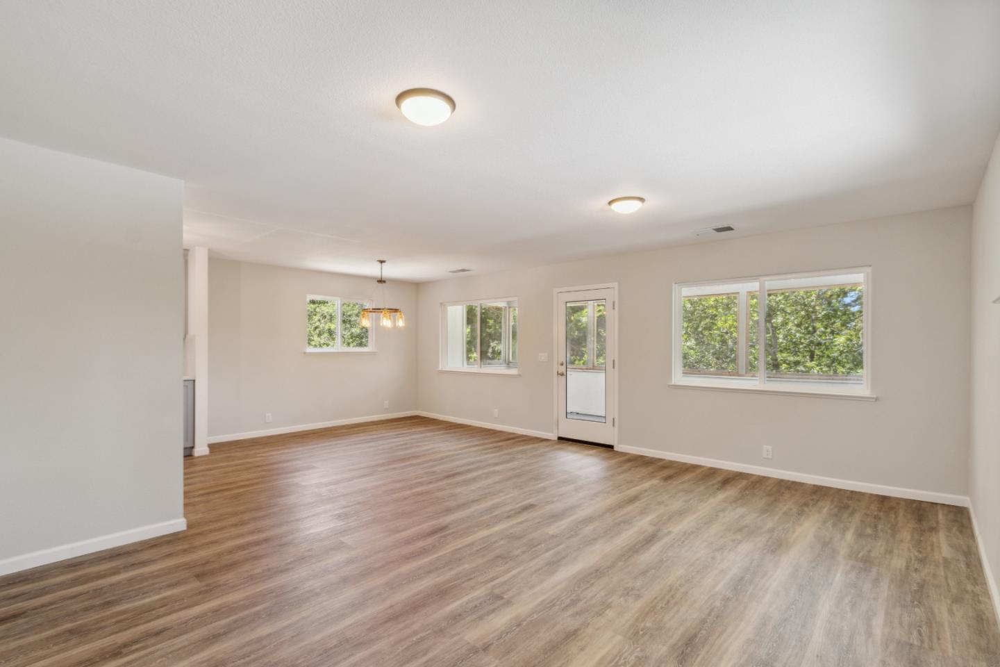 24895 Skyland Road Los Gatos, CA 95033 - Photo 5 of 113 an empty room with wooden floor and windows