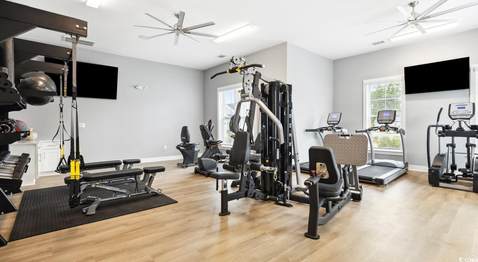 31 Quaker Rdg Drive, Unit MEANDER Carolina Shores, NC 28467 - Photo 15 of 38 Exercise room featuring light wood-style floors and a ceiling fan