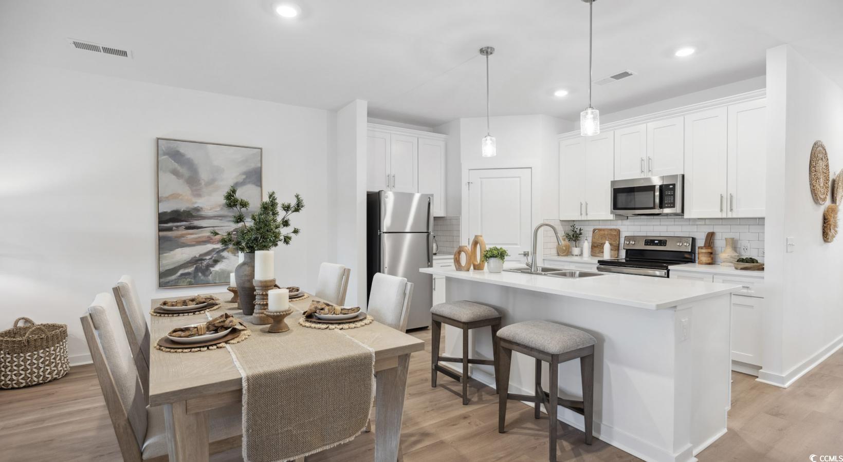 31 Quaker Rdg Drive, Unit MEANDER Carolina Shores, NC 28467 - Photo 17 of 38 Kitchen with stainless steel appliances, decorative backsplash, light wood-style flooring, light countertops, and recessed lighting