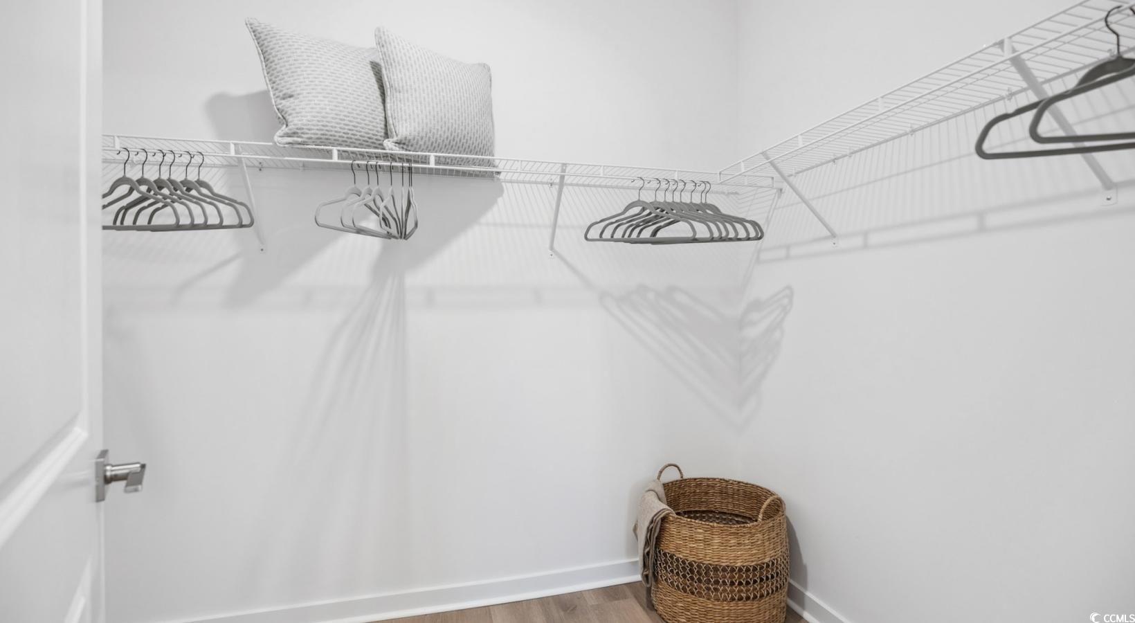 31 Quaker Rdg Drive, Unit MEANDER Carolina Shores, NC 28467 - Photo 24 of 38 Walk in closet with wood finished floors