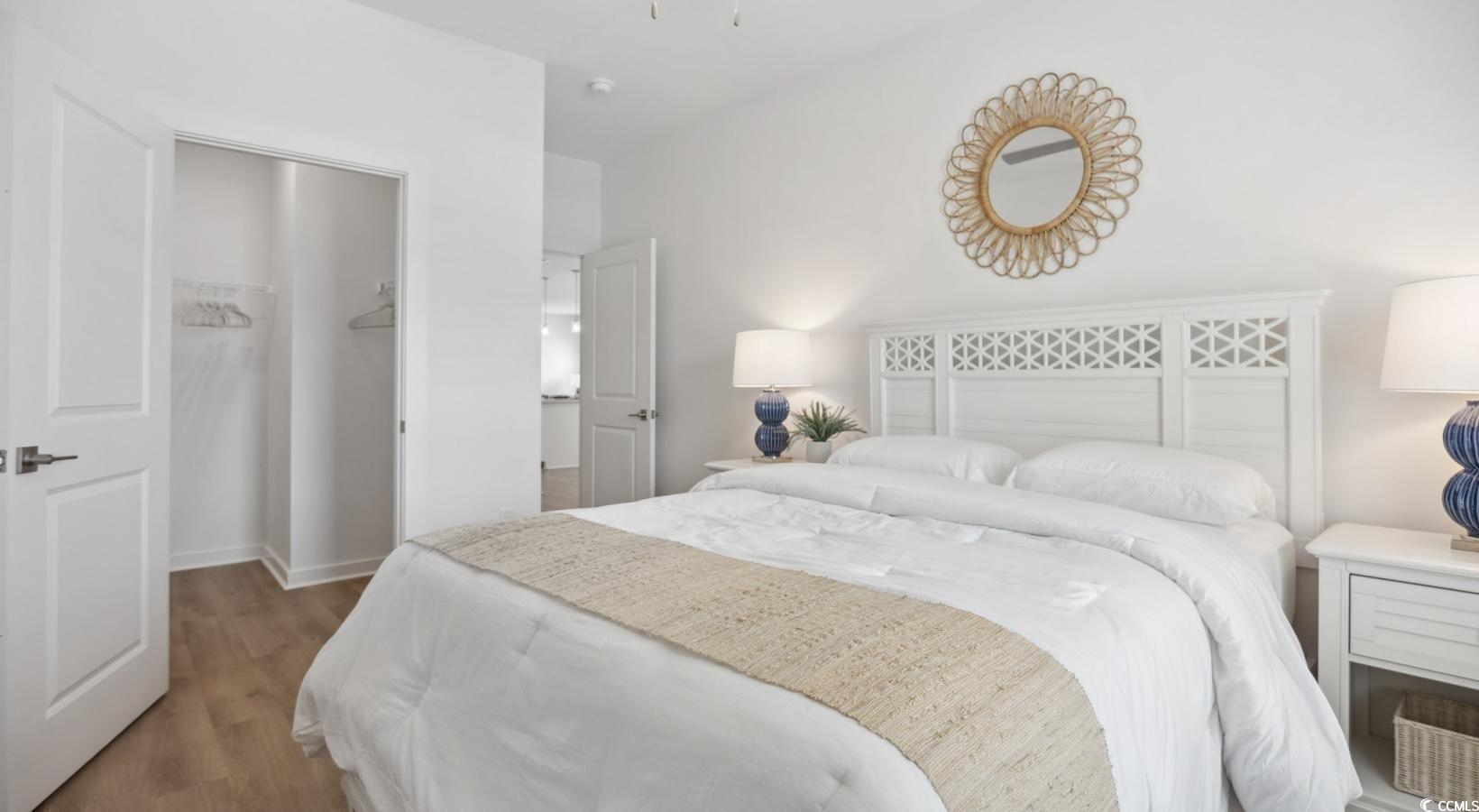 31 Quaker Rdg Drive, Unit MEANDER Carolina Shores, NC 28467 - Photo 25 of 38 Bedroom with a walk in closet and wood finished floors