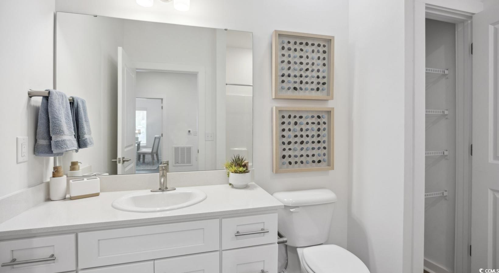 31 Quaker Rdg Drive, Unit MEANDER Carolina Shores, NC 28467 - Photo 26 of 38 Bathroom featuring vanity and a walk in closet