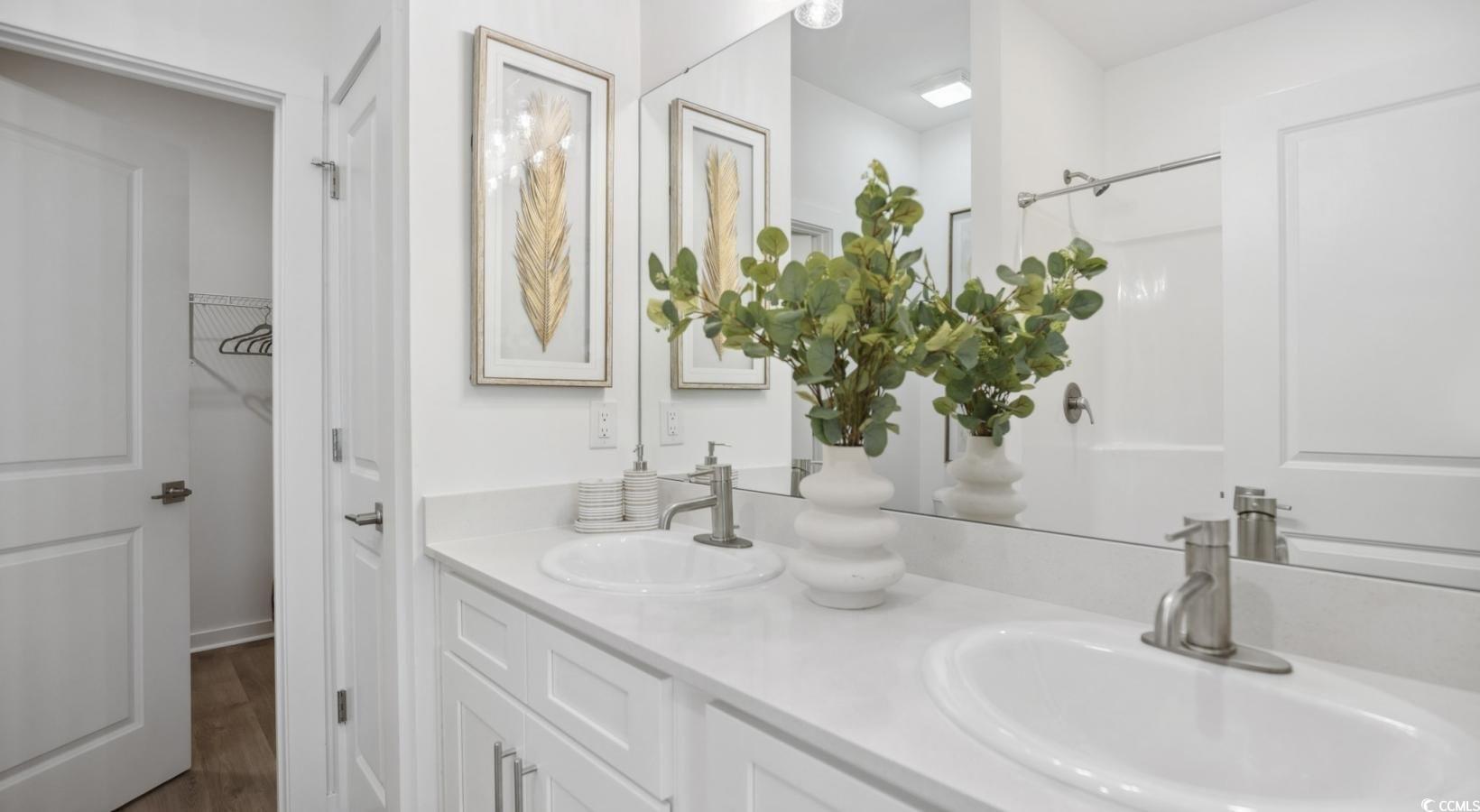 31 Quaker Rdg Drive, Unit MEANDER Carolina Shores, NC 28467 - Photo 27 of 38 Full bathroom with double vanity, wood finished floors, and a closet