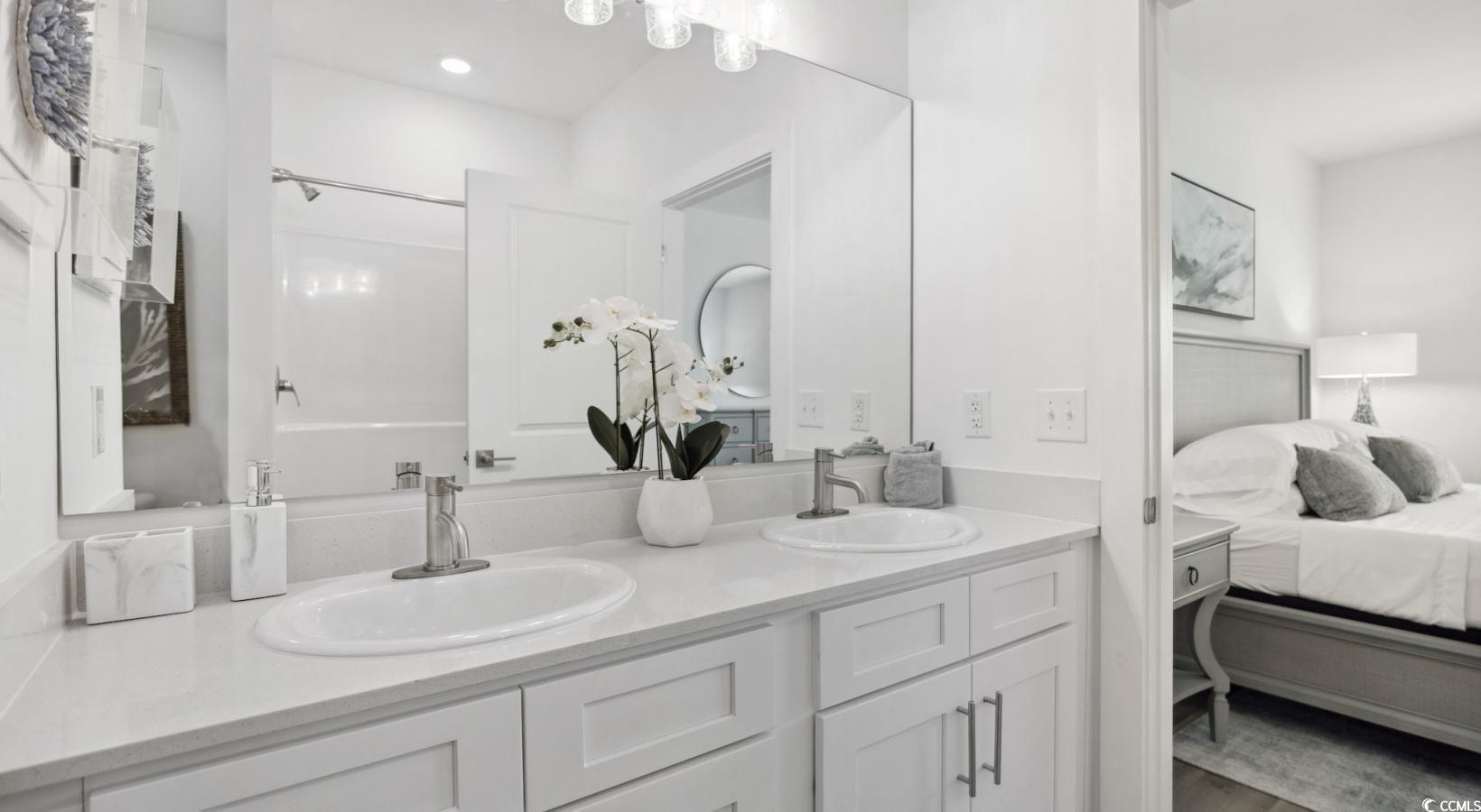 31 Quaker Rdg Drive, Unit MEANDER Carolina Shores, NC 28467 - Photo 31 of 38 Ensuite bathroom with double vanity and bathing tub / shower combination