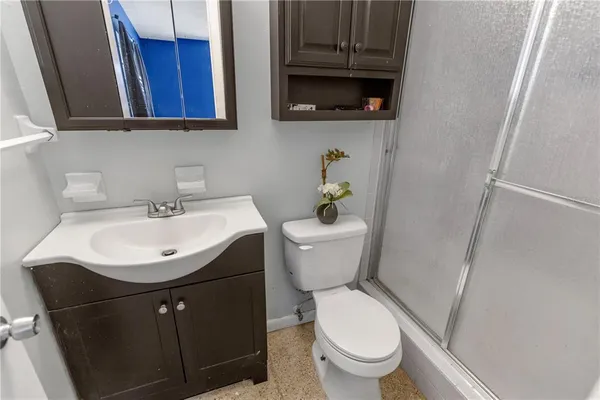 a bathroom with a sink toilet and a mirror