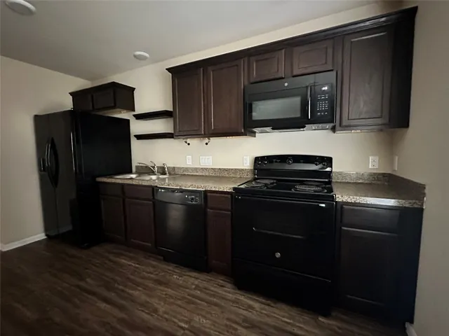 a kitchen with a sink stove and refrigerator