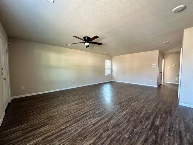 a view of a room with wooden floor and white walls
