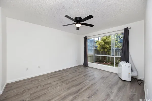 a view of a livingroom with a hardwood floor and a ceiling fan