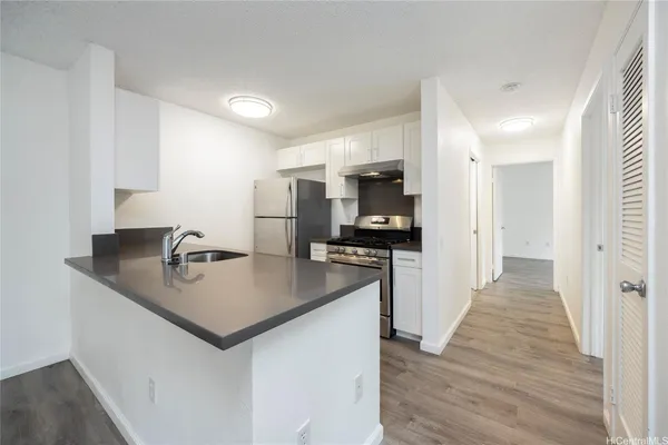 a kitchen with a sink a counter top space and appliances
