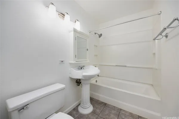 a bathroom with a sink a toilet and bathtub