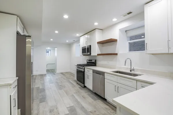 a kitchen with a sink stainless steel appliances and cabinets