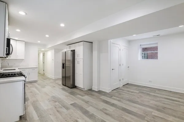 a view of a kitchen with a sink and a refrigerator