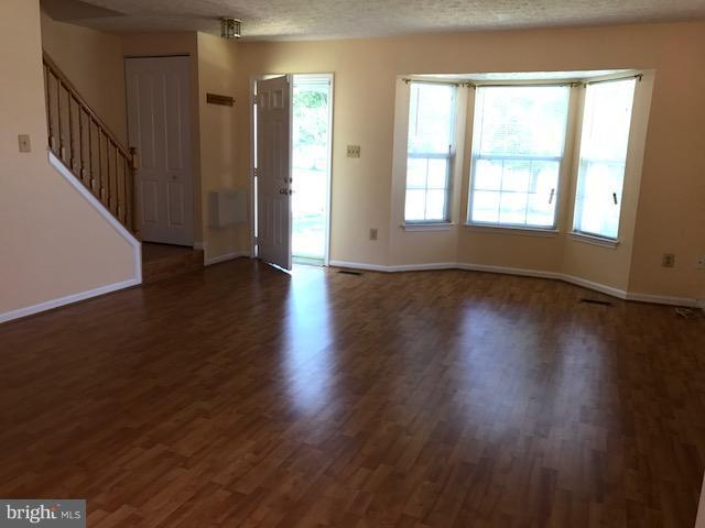 2100 Riding Crop Way Baltimore, MD 21244 - Photo 3 of 10 a view of an empty room with wooden floor and a window