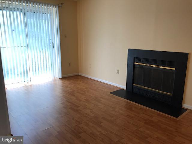 2100 Riding Crop Way Baltimore, MD 21244 - Photo 8 of 10 a living room with wooden floor and a fireplace