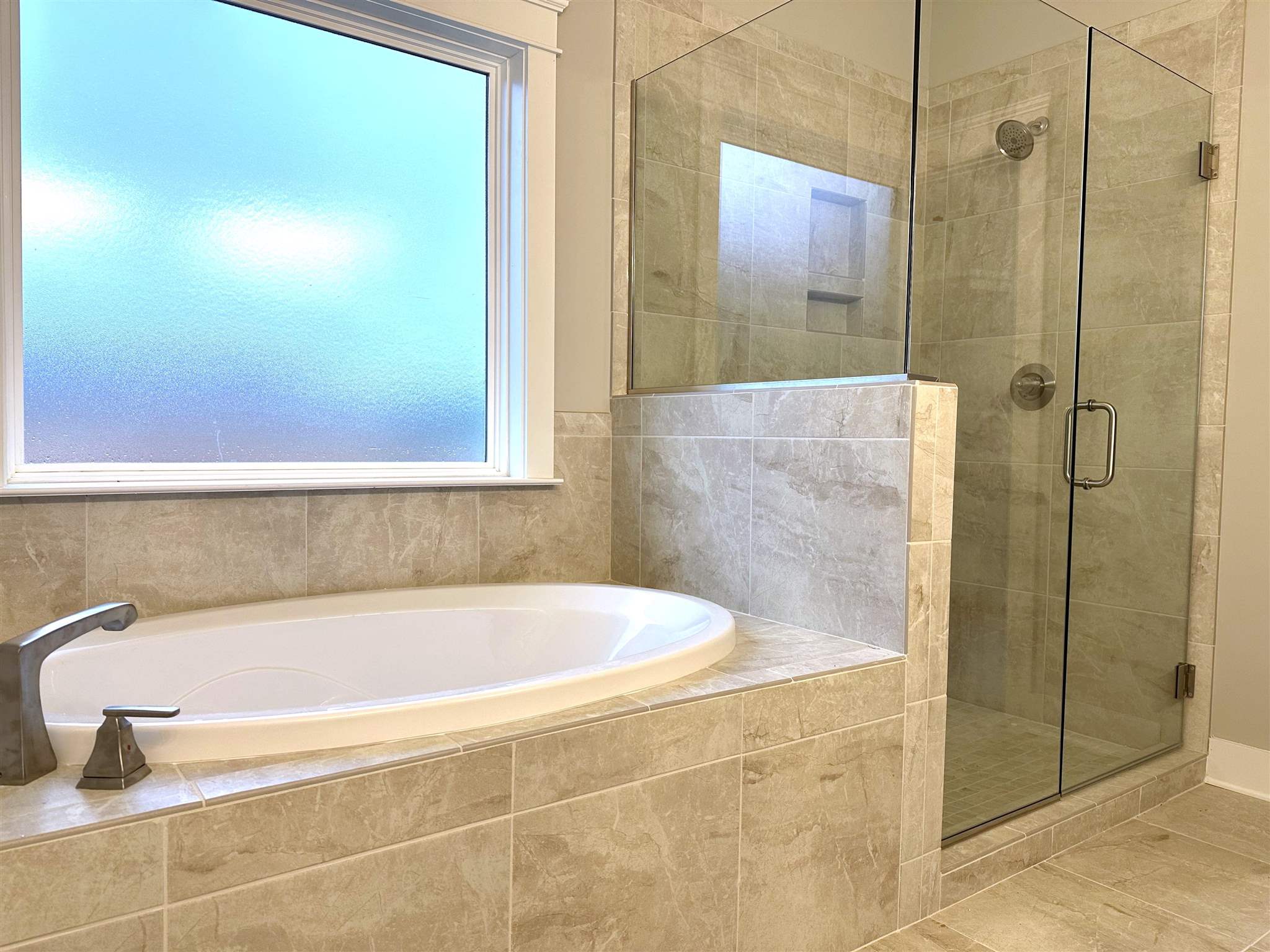 6264 Howie Way Pace, FL 32571 - Photo 14 of 34 a bathroom with a bathtub and shower