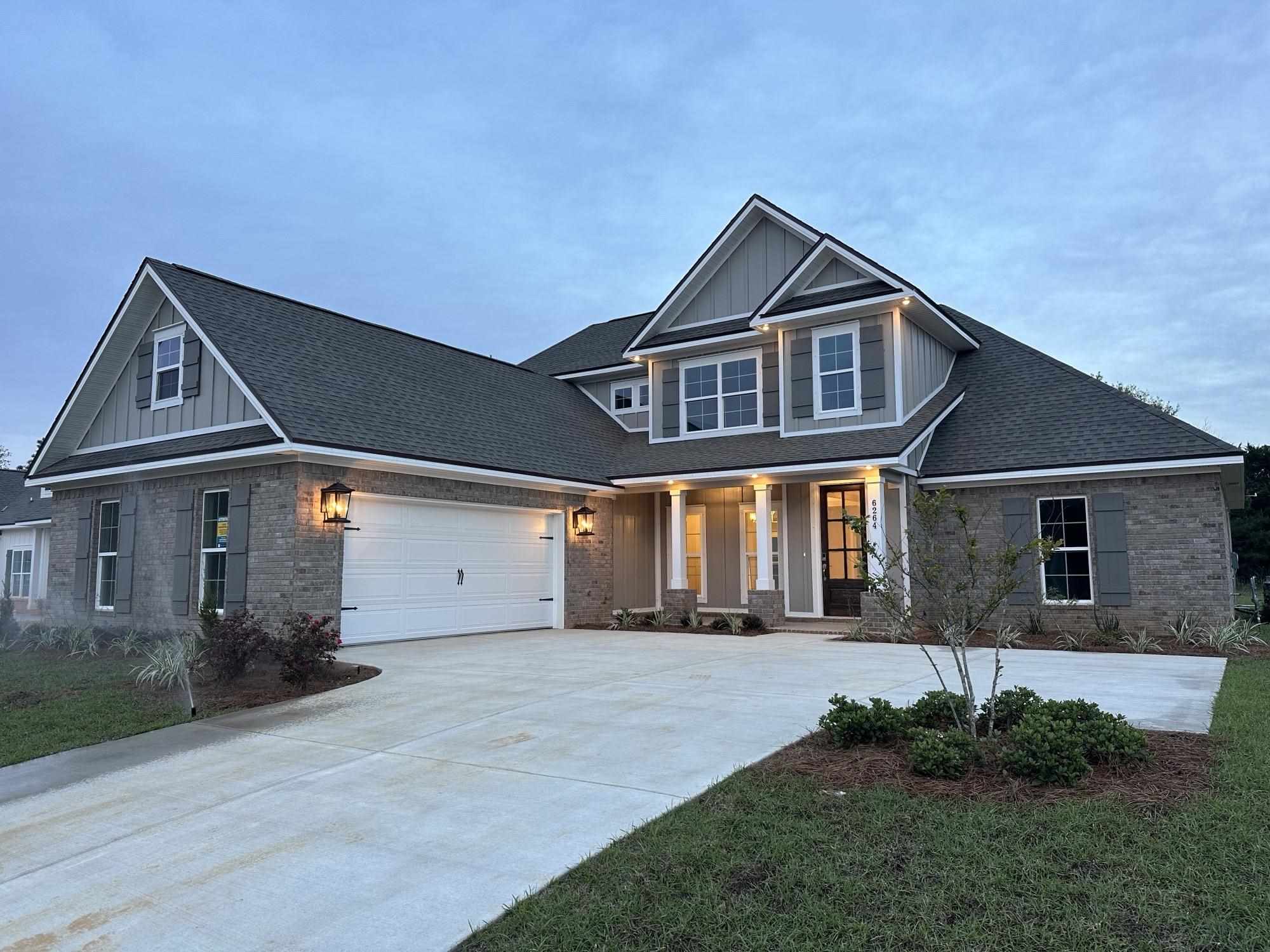 6264 Howie Way Pace, FL 32571 - Photo 2 of 34 a front view of a house with a yard and garage