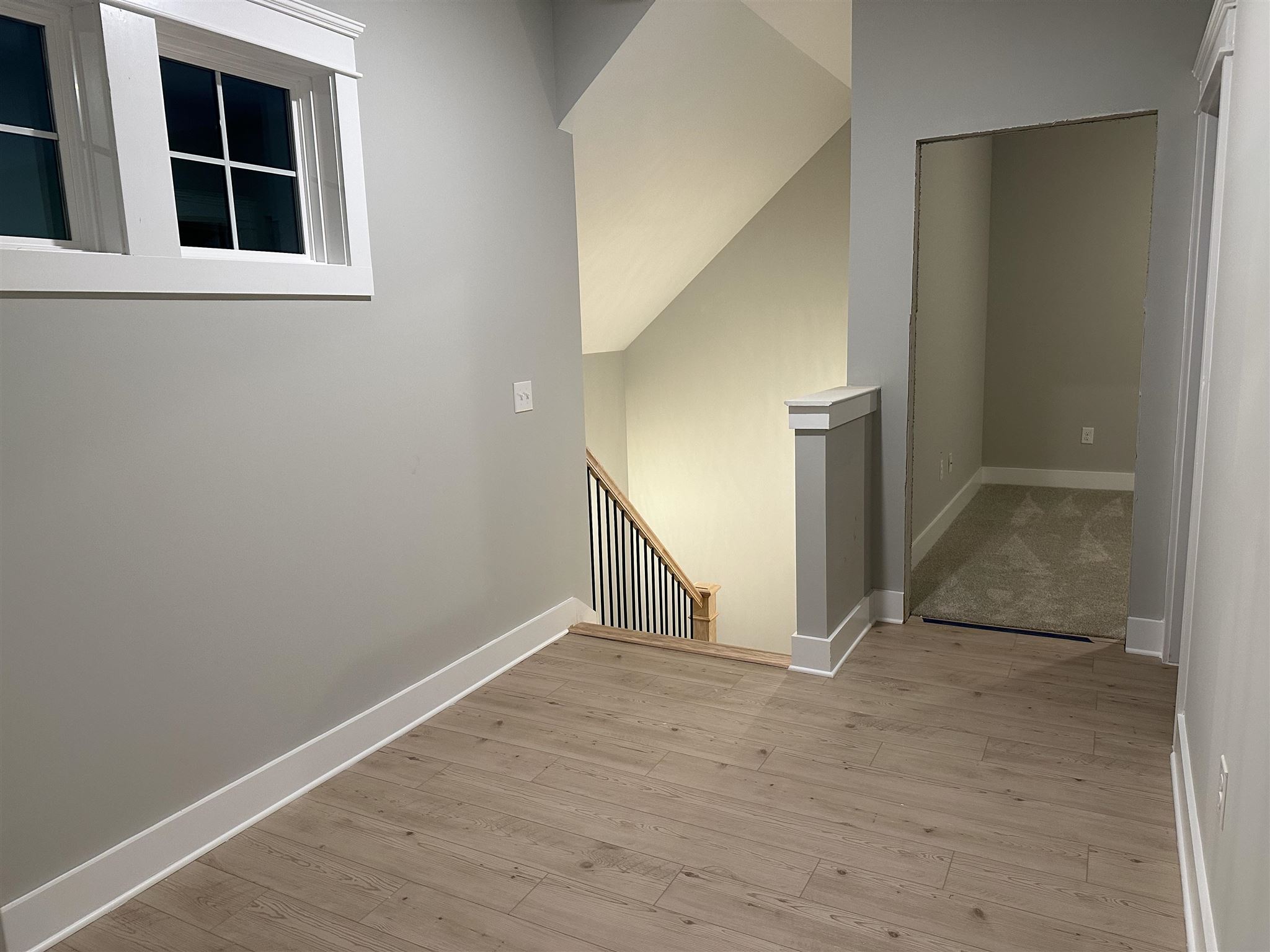 6264 Howie Way Pace, FL 32571 - Photo 26 of 34 a view of an empty room with wooden floor and stairs
