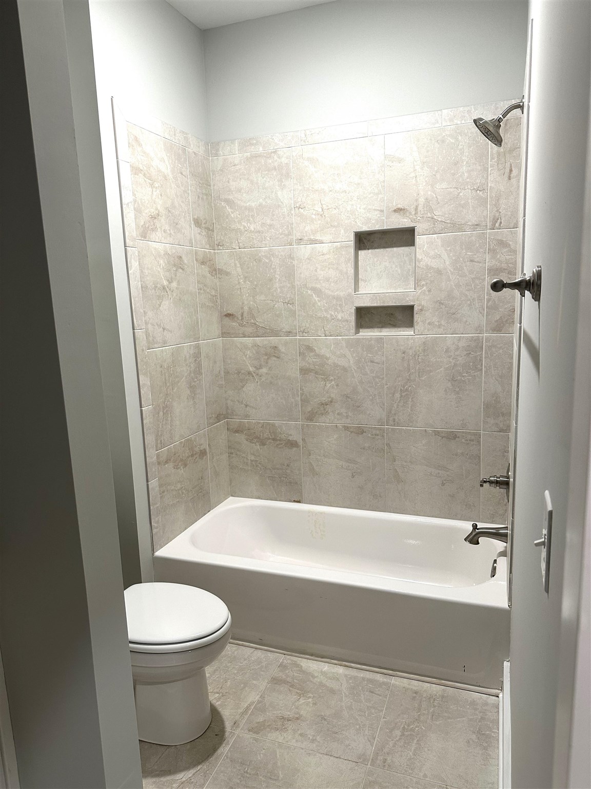 6264 Howie Way Pace, FL 32571 - Photo 30 of 34 a bathroom with a bathtub and a toilet