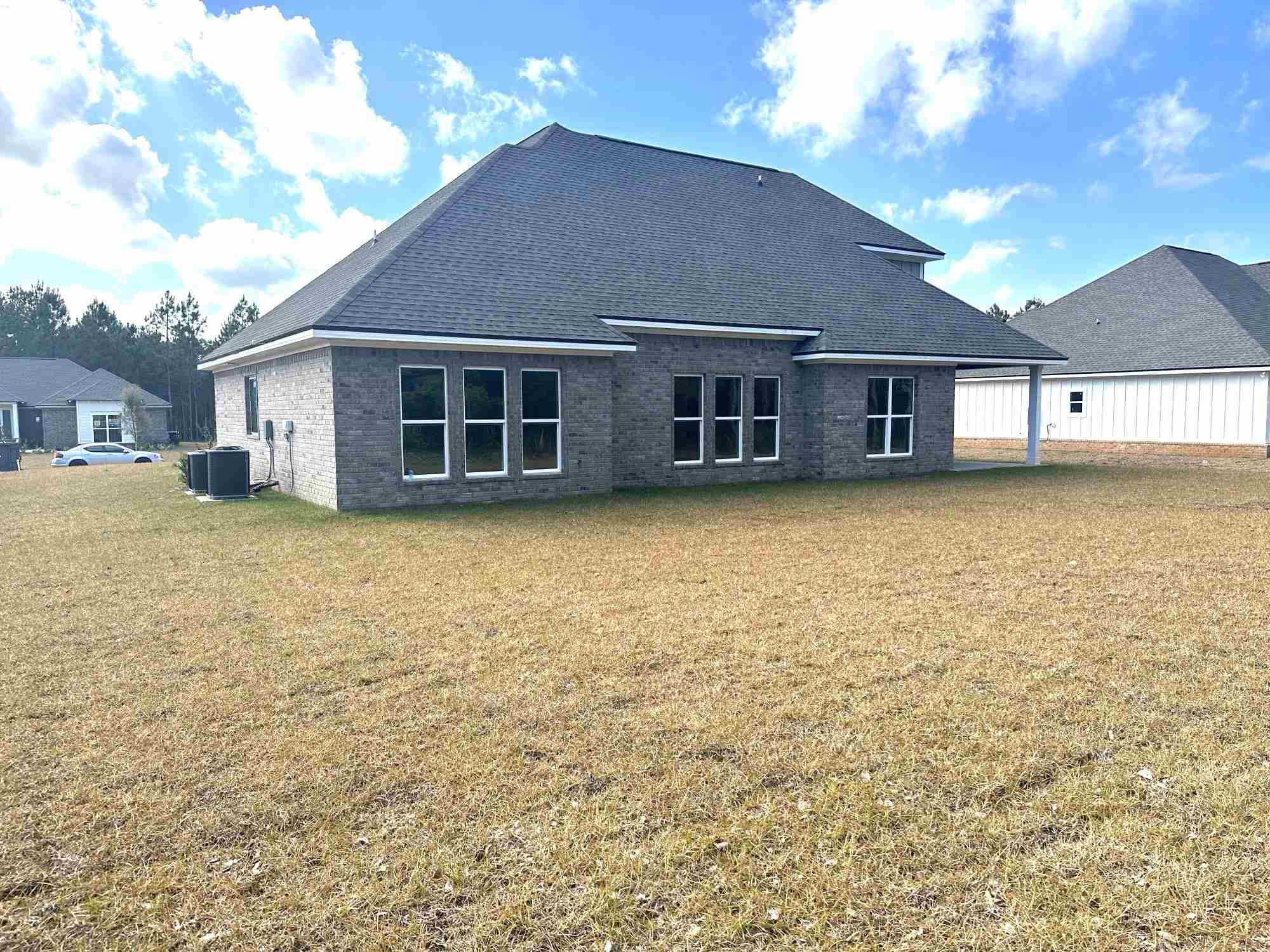 6264 Howie Way Pace, FL 32571 - Photo 33 of 34 a view of a house with a yard