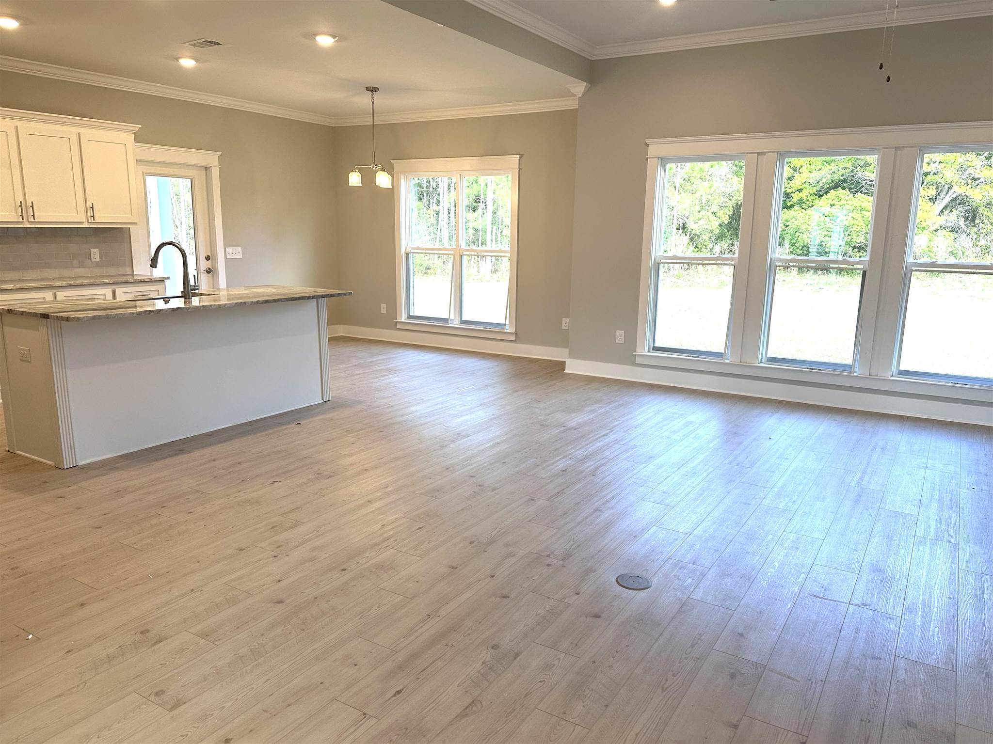 6264 Howie Way Pace, FL 32571 - Photo 5 of 34 a view of a kitchen with wooden floor and a window