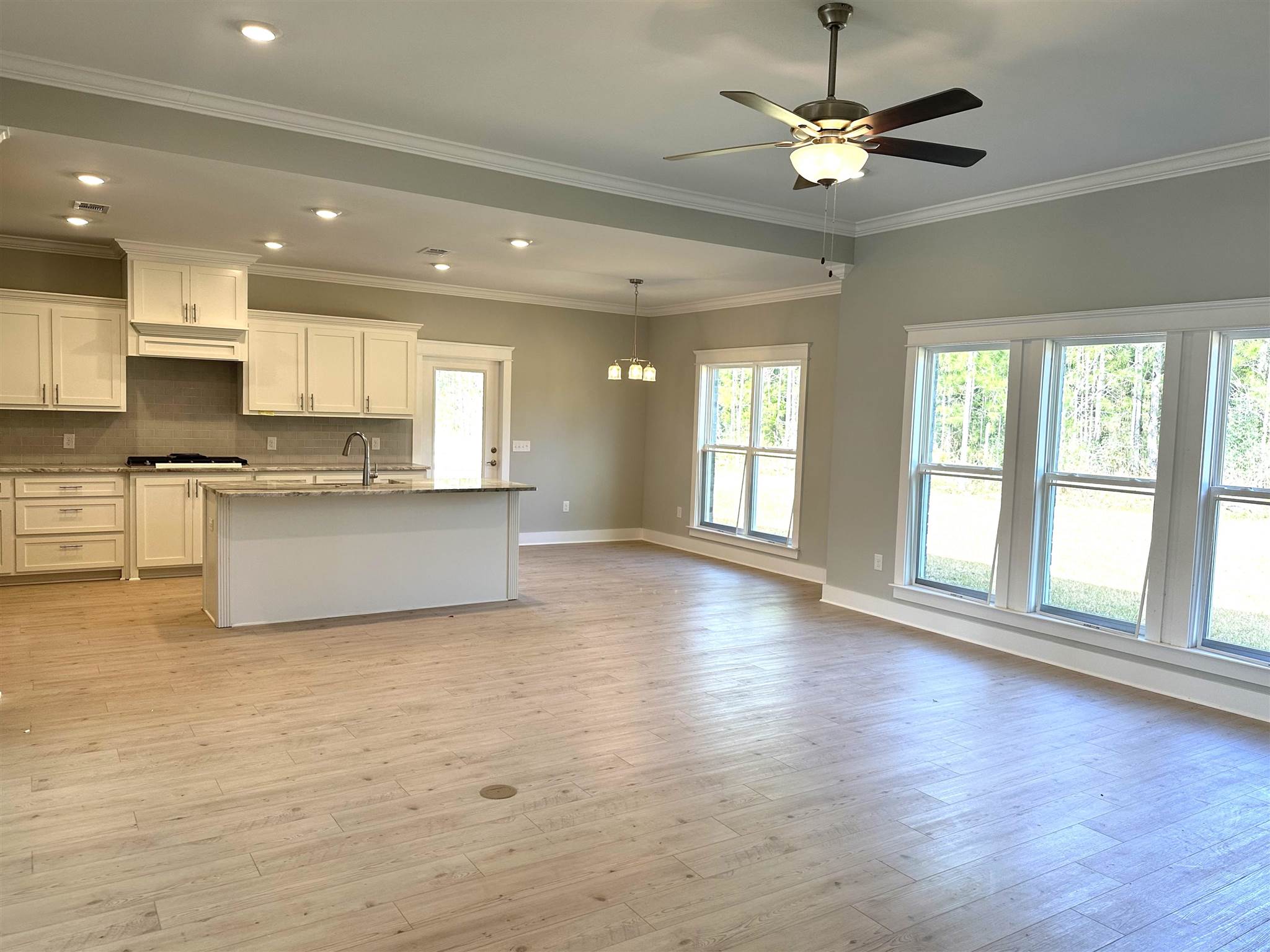 6264 Howie Way Pace, FL 32571 - Photo 6 of 34 a view of an empty room with kitchen and window