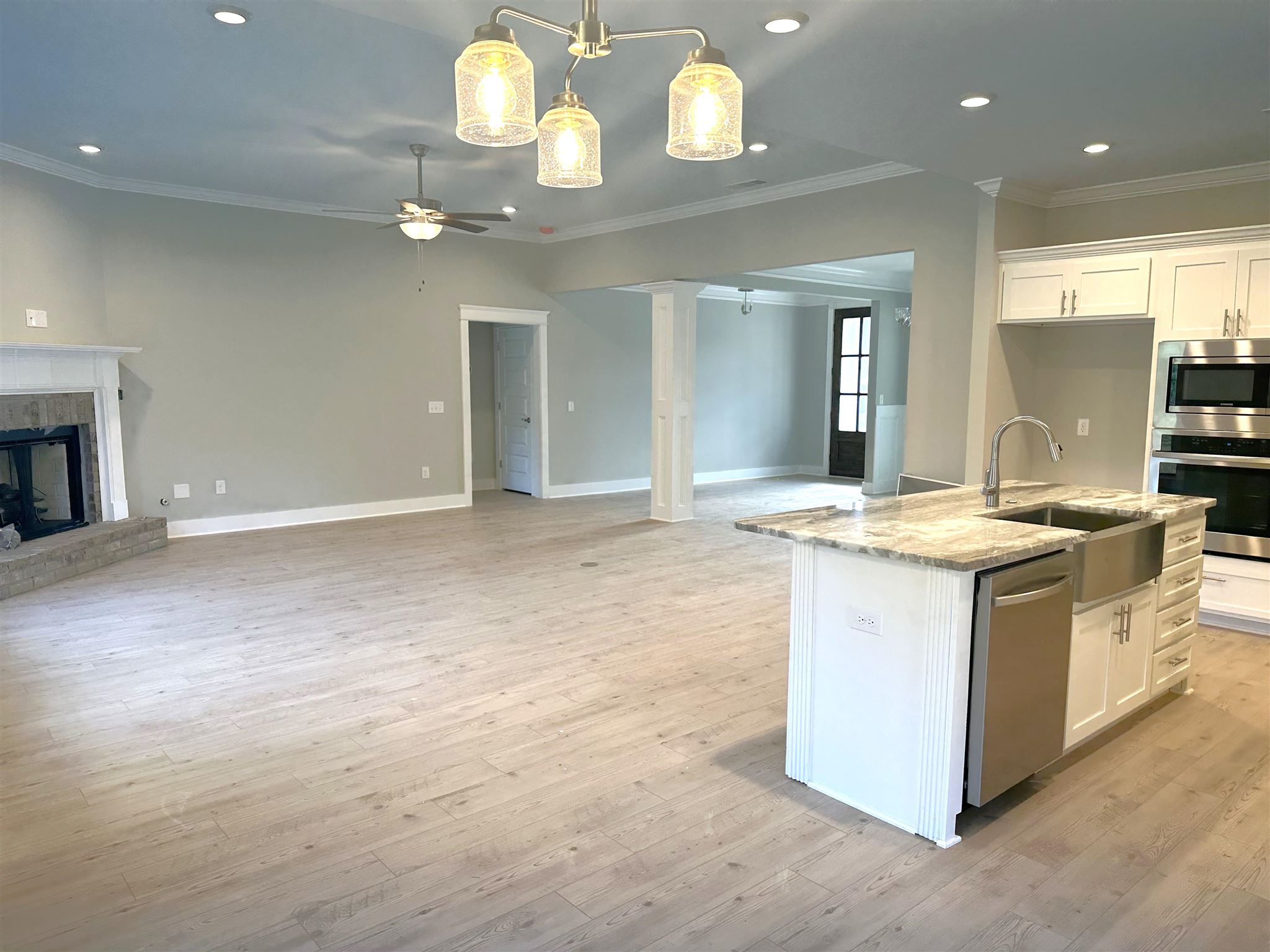6264 Howie Way Pace, FL 32571 - Photo 7 of 34 a large white kitchen with a large island