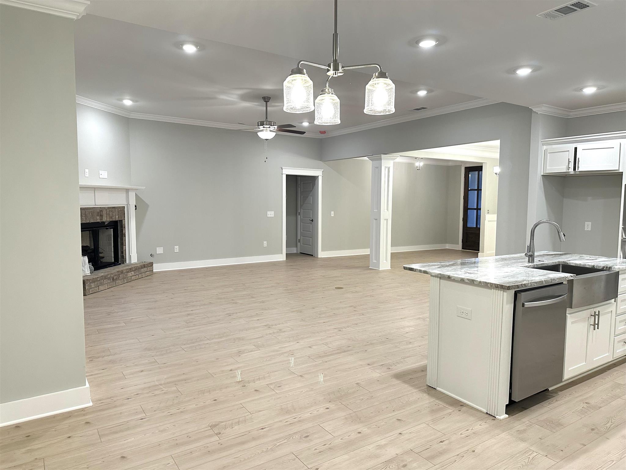 6264 Howie Way Pace, FL 32571 - Photo 8 of 34 a view of a kitchen with a sink and chandelier