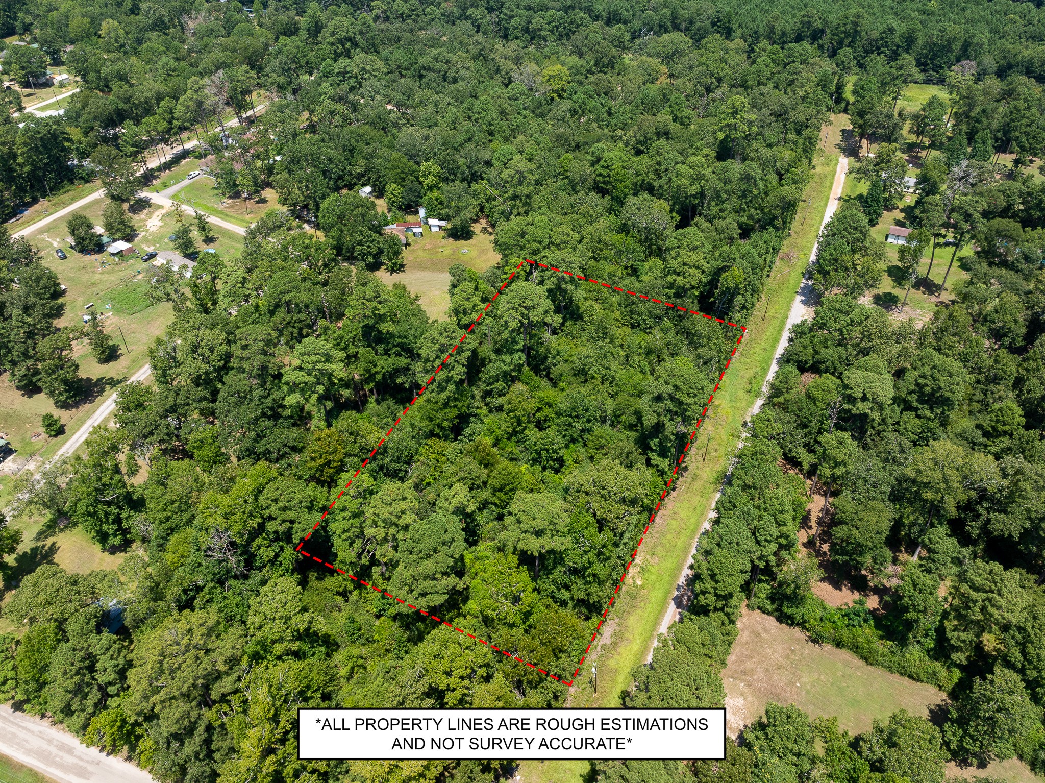 an aerial view of a residential houses with yard