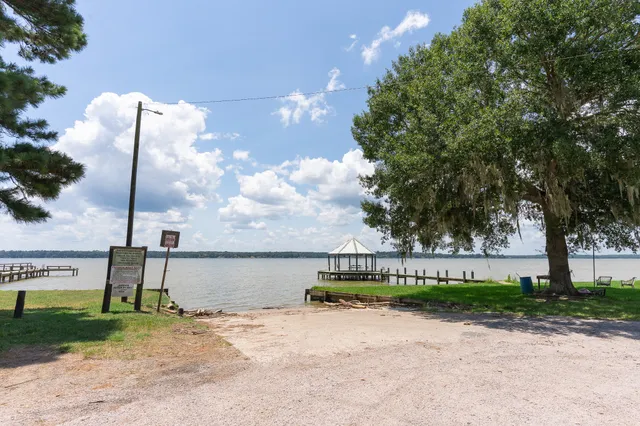 a view of a lake with couches in front of house