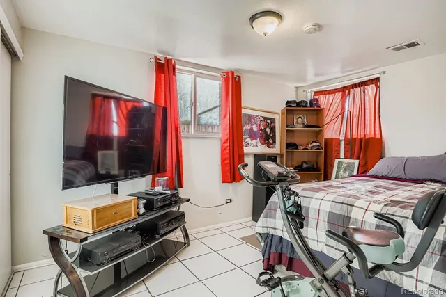 a bedroom with furniture and a flat screen tv